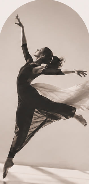 Dancer in a contemporary leap, fabric trailing