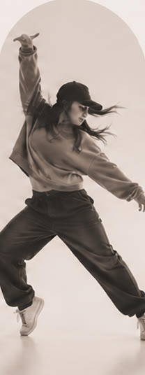 Dancer in a hip hop pose wearing a cap