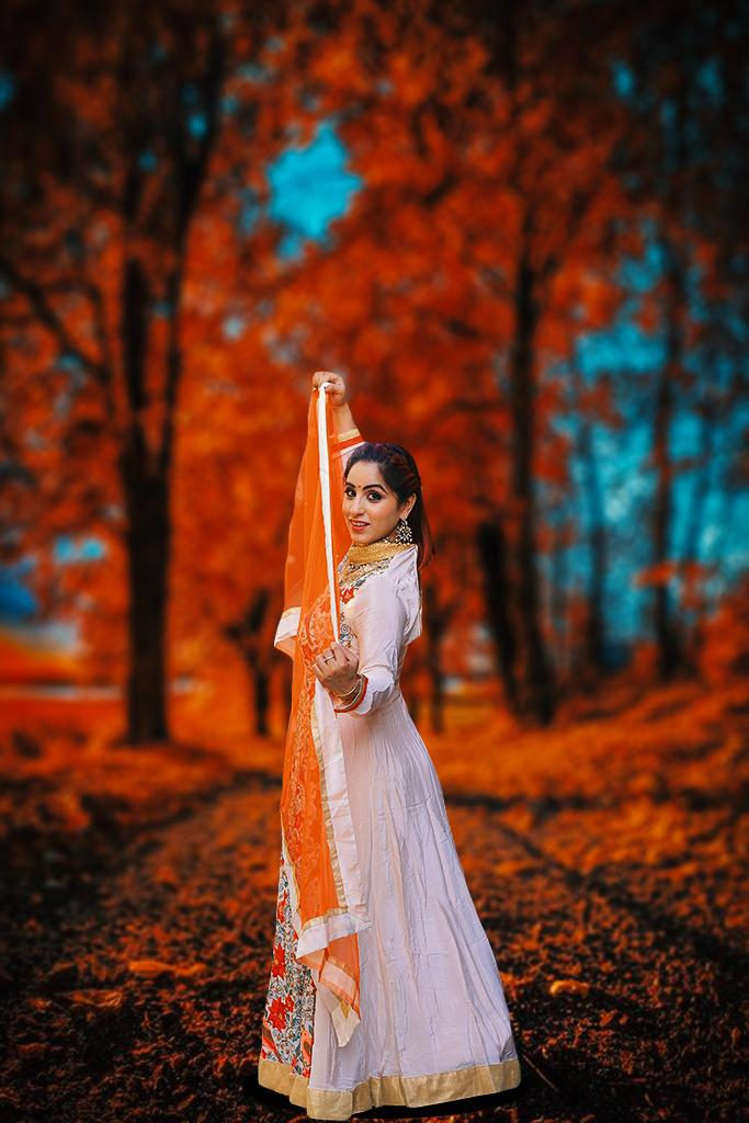 Ritika in an orange dupatta among autumn trees