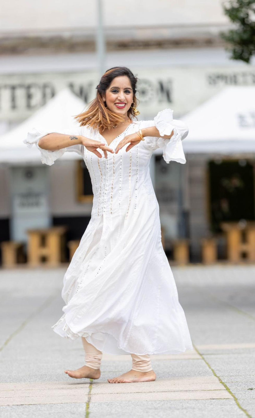 Ritika Arora dancing in a white dress